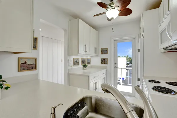 a kitchen with furniture a refrigerator and a stove