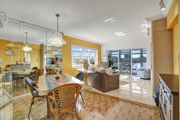 a very nice looking open dining room with a large window