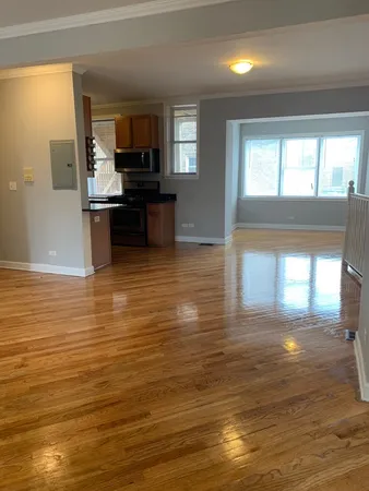 a kitchen with stainless steel appliances wooden cabinets a stove and a refrigerator
