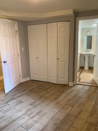 an empty room with window in bathroom