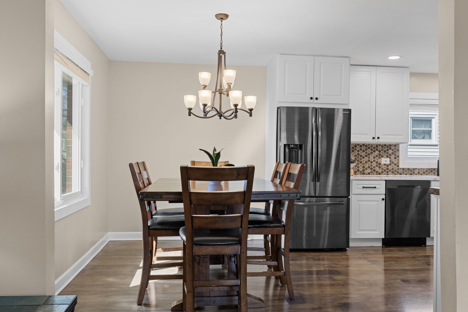 N151 Stanley Street Winfield, IL 60190 - Photo 11 of 27 a kitchen with stainless steel appliances a dining table chairs and refrigerator