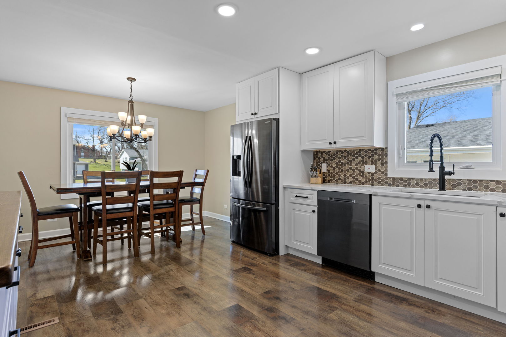 N151 Stanley Street Winfield, IL 60190 - Photo 15 of 27 a kitchen with refrigerator a sink dining table and chairs