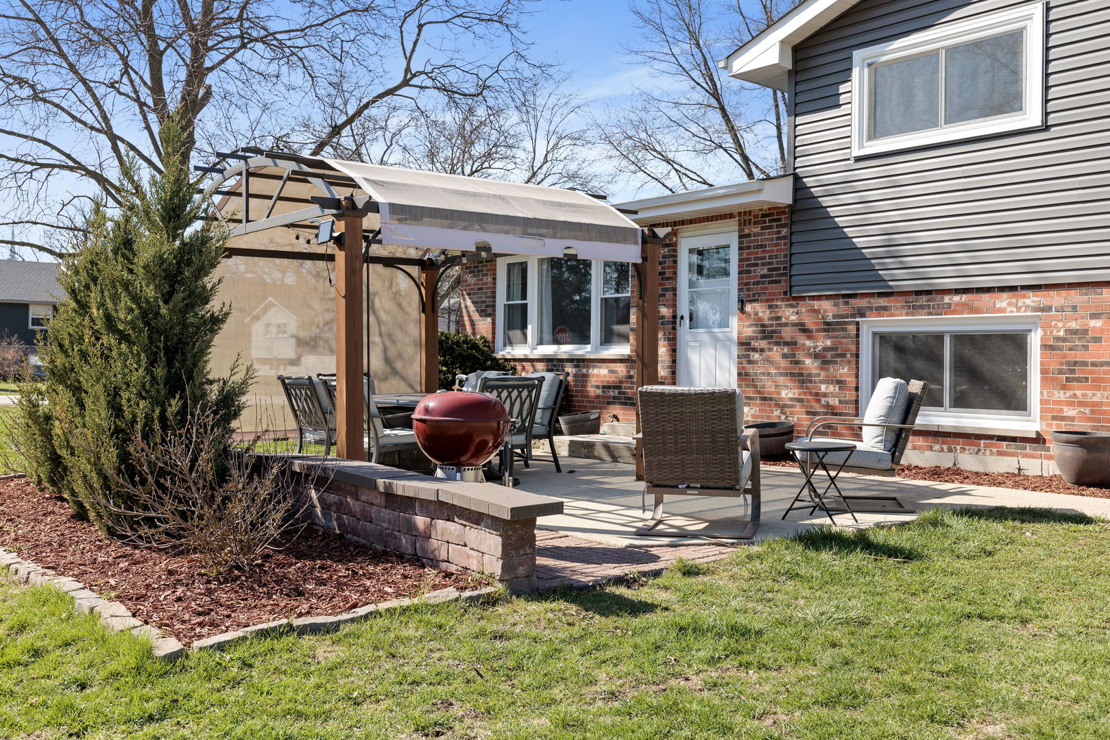 N151 Stanley Street Winfield, IL 60190 - Photo 25 of 27 a view of a patio with table and chairs potted plants and a large tree