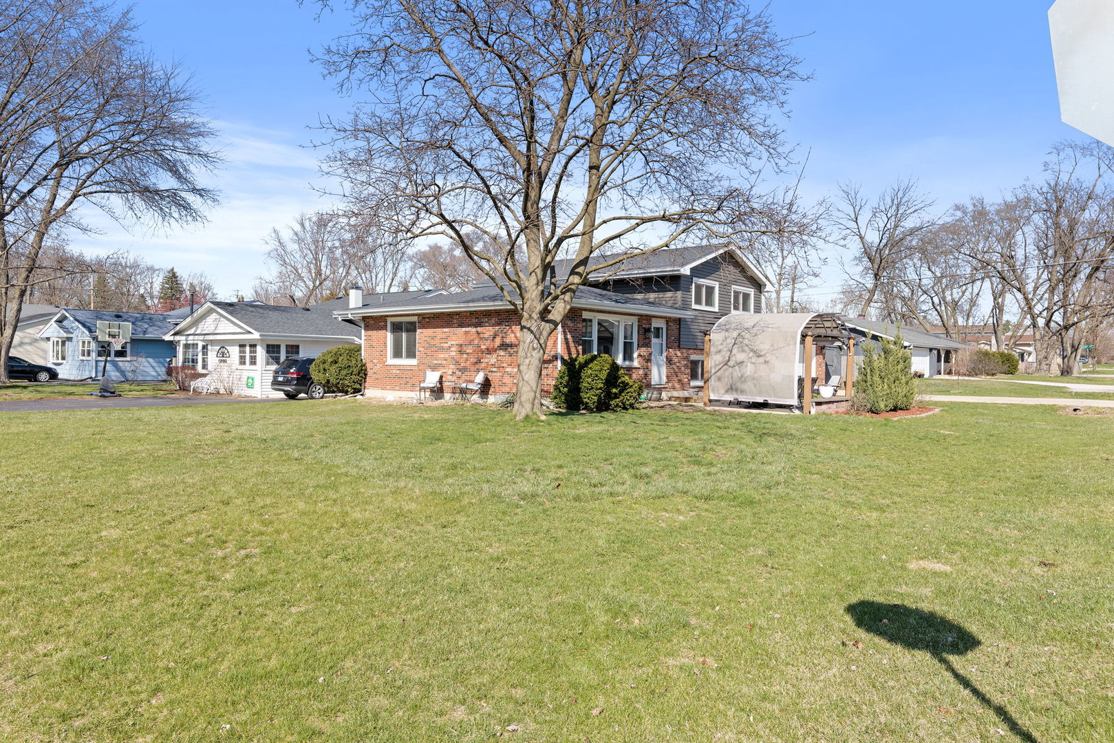 N151 Stanley Street Winfield, IL 60190 - Photo 26 of 27 a front view of house with yard and trees in the background