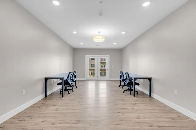 a view of a work space with furniture and wooden floor