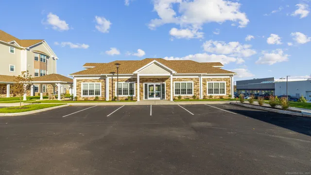 a front view of residential houses with yard and parking space