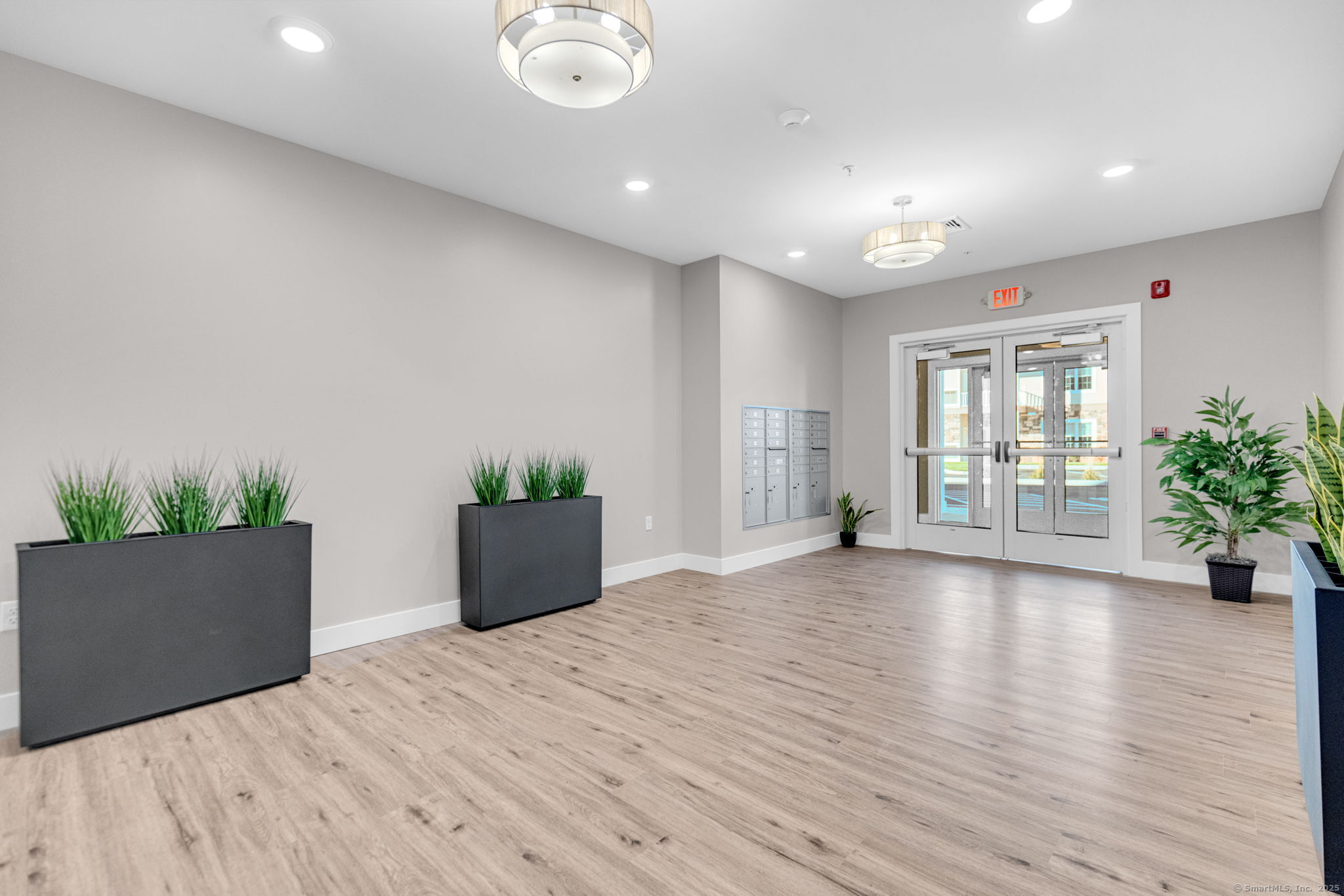 104 Episcopal Road, Unit 2 Berlin, CT 06037 - Photo 5 of 20 an empty room with wooden floor and windows