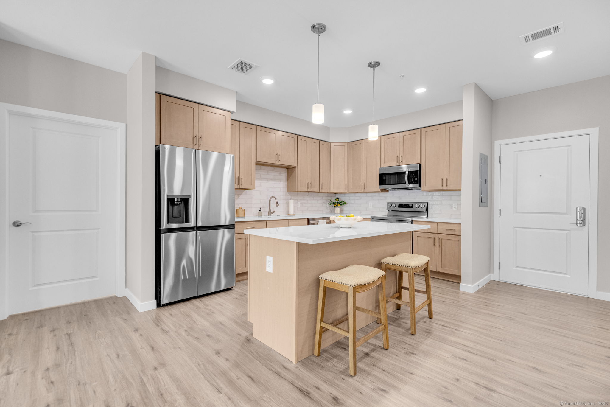 104 Episcopal Road, Unit 2 Berlin, CT 06037 - Photo 7 of 20 a kitchen with stainless steel appliances granite countertop a refrigerator a sink dishwasher a stove and white cabinets with wooden floor