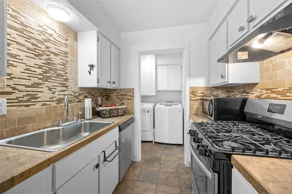 a kitchen with a sink stove and cabinets