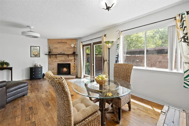a living room with furniture fireplace and a table