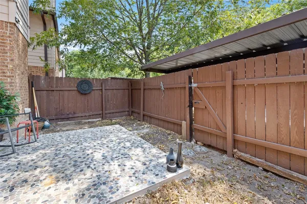 a backyard of a house with a tree