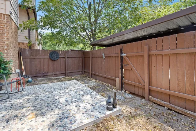 a backyard of a house with a tree