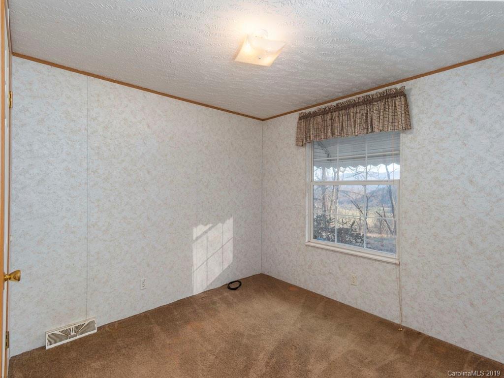 3321 Crabtree Road Waynesville, NC 28785 - Photo 22 of 25 a view of an empty room with a window