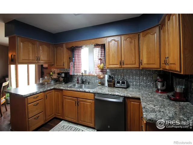 a kitchen with a sink a window and cabinets