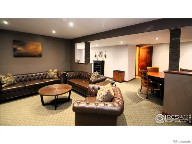 a living room with furniture a flat screen tv and a table