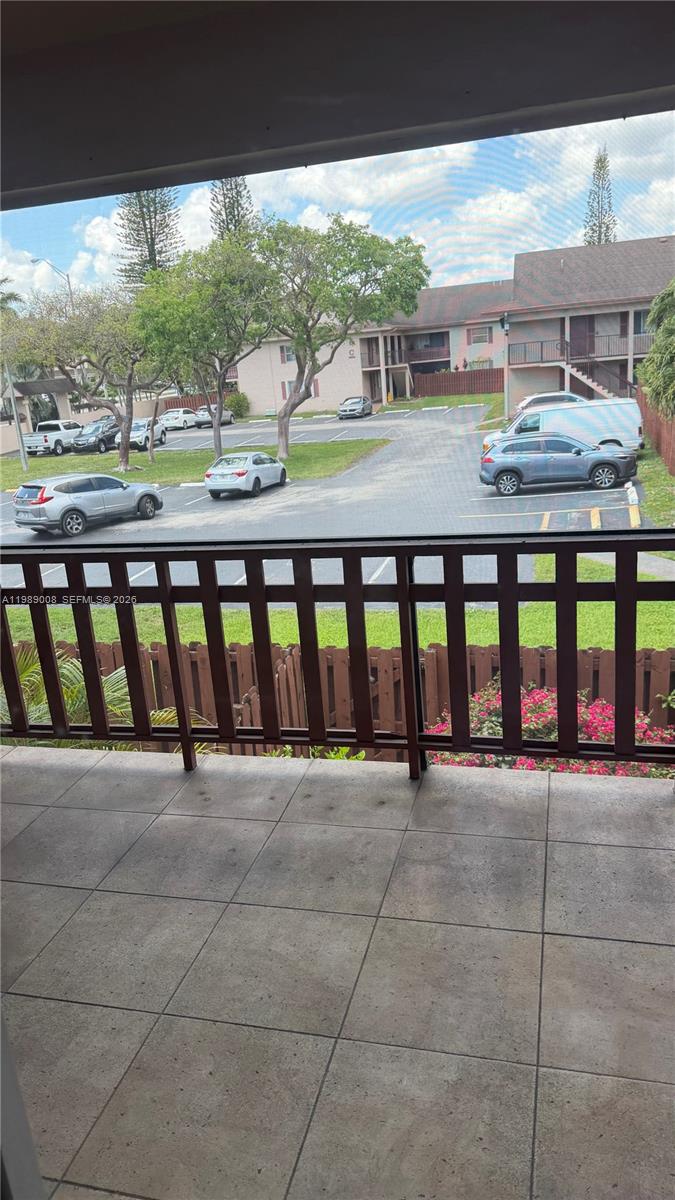11207 Southwest 88th Street, Unit 216A Miami, FL 33176 - Photo 1 of 9 a view of a porch with a floor to ceiling window next to a yard