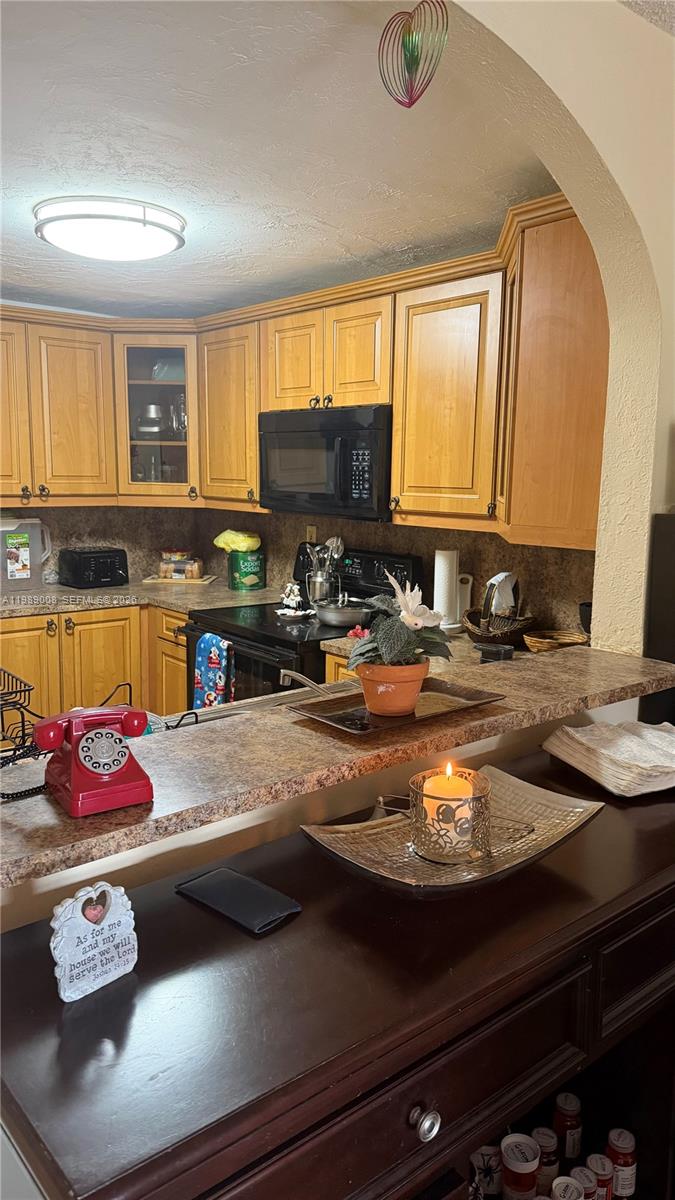 11207 Southwest 88th Street, Unit 216A Miami, FL 33176 - Photo 3 of 9 a kitchen with a sink appliances and cabinets