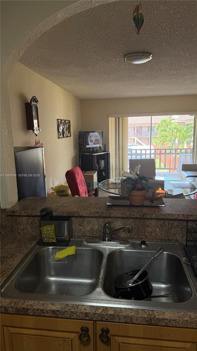 11207 Southwest 88th Street, Unit 216A Miami, FL 33176 - Photo 4 of 9 a kitchen with a sink and a window