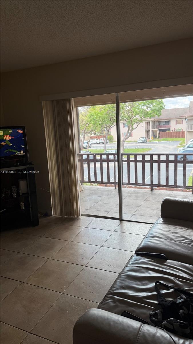 11207 Southwest 88th Street, Unit 216A Miami, FL 33176 - Photo 5 of 9 a view of a living room and a balcony