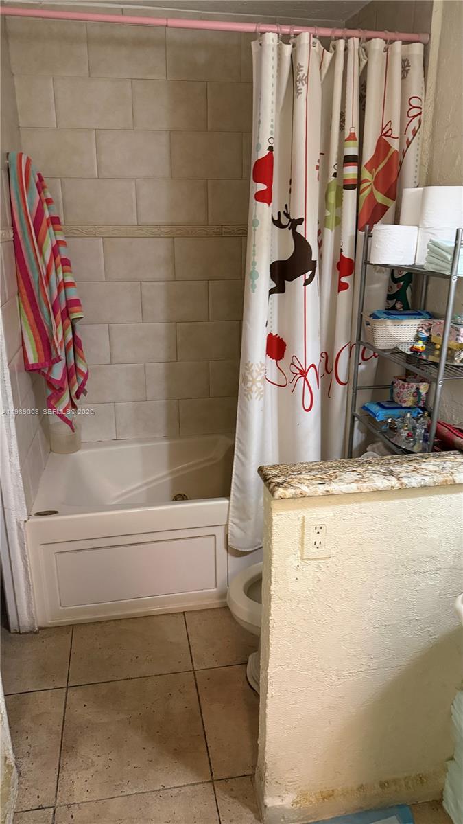 11207 Southwest 88th Street, Unit 216A Miami, FL 33176 - Photo 6 of 9 a bathroom with a granite countertop sink a toilet and bathtub