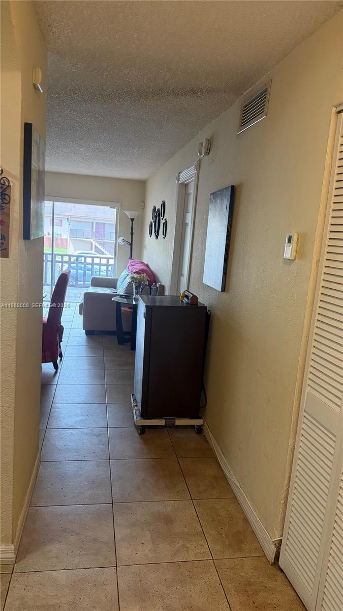 11207 Southwest 88th Street, Unit 216A Miami, FL 33176 - Photo 9 of 9 a living room with furniture and a window