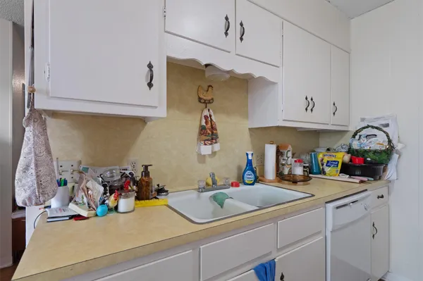 a kitchen with sink cabinets and appliances