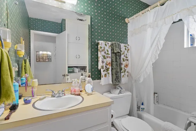 a view of a backyard with a tree