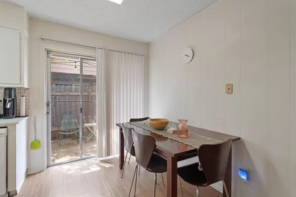 a view of a dining room with furniture and a window
