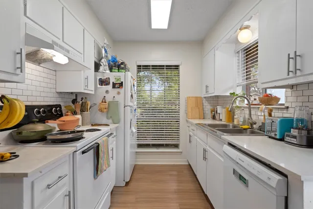 a view of kitchen appliances and cabinets