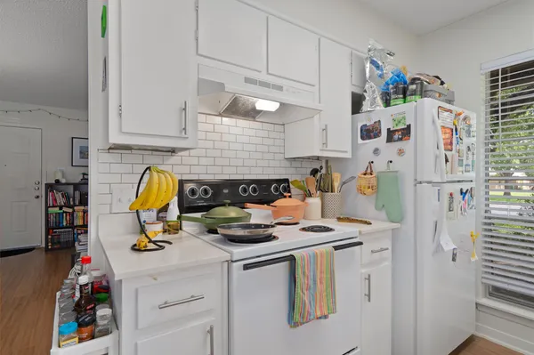 a view of kitchen appliances and cabinets