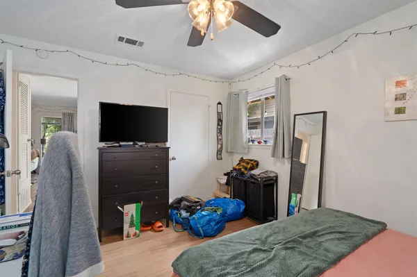 a bedroom with a bed and a flat screen tv