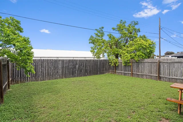 a backyard of a house with table and chairs