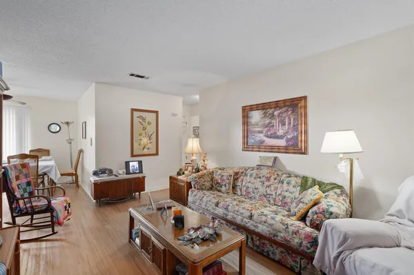 a living room with furniture a lamp next to a window