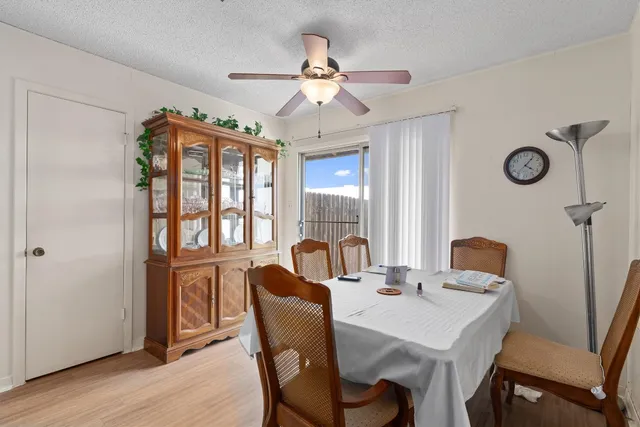 a dining room with furniture a chandelier and window