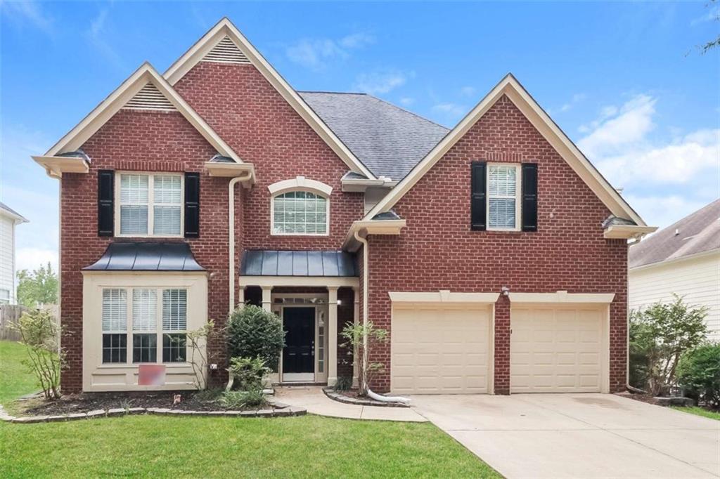 445 Fitzgerald Place Atlanta, GA 30349 - Photo 1 of 15 front view of house with a yard
