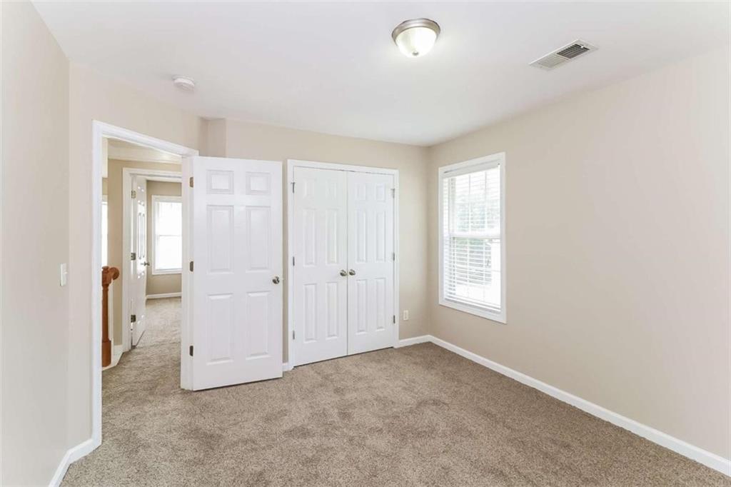 445 Fitzgerald Place Atlanta, GA 30349 - Photo 14 of 15 an empty room with windows and closet
