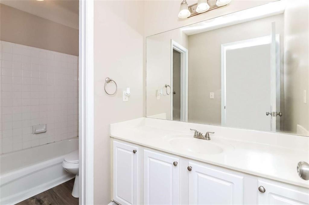 445 Fitzgerald Place Atlanta, GA 30349 - Photo 15 of 15 a bathroom with a sink a toilet and shower