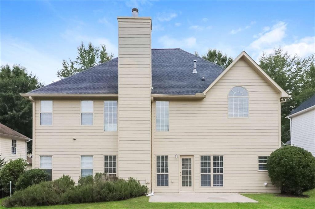 445 Fitzgerald Place Atlanta, GA 30349 - Photo 2 of 15 a front view of a house with garden