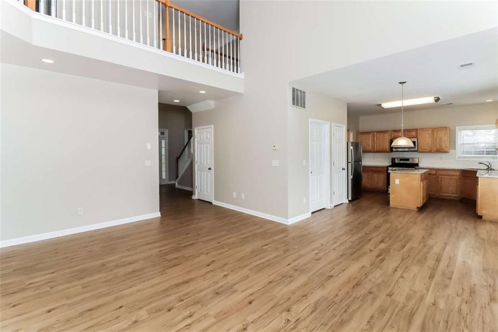 445 Fitzgerald Place Atlanta, GA 30349 - Photo 3 of 15 a view of a kitchen with furniture and wooden floor