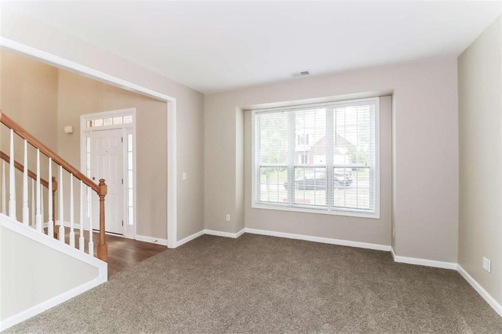 445 Fitzgerald Place Atlanta, GA 30349 - Photo 4 of 15 a view of an empty room with wooden floor and a window