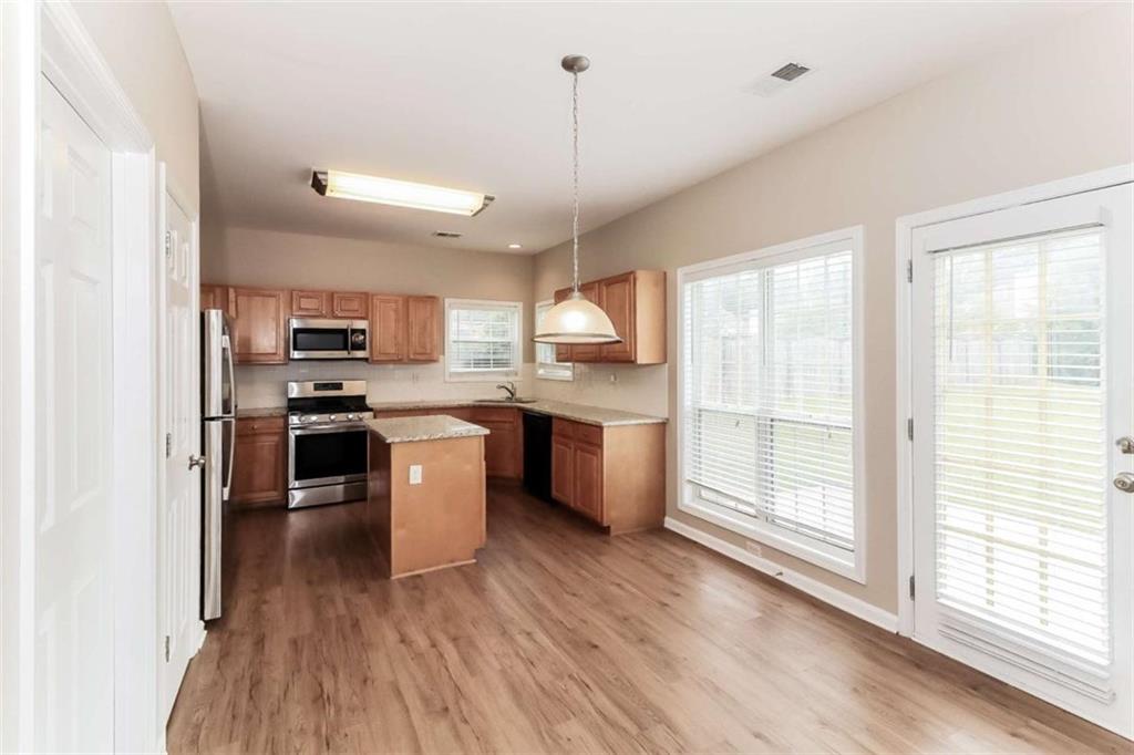 445 Fitzgerald Place Atlanta, GA 30349 - Photo 9 of 15 a kitchen with stove a sink and refrigerator