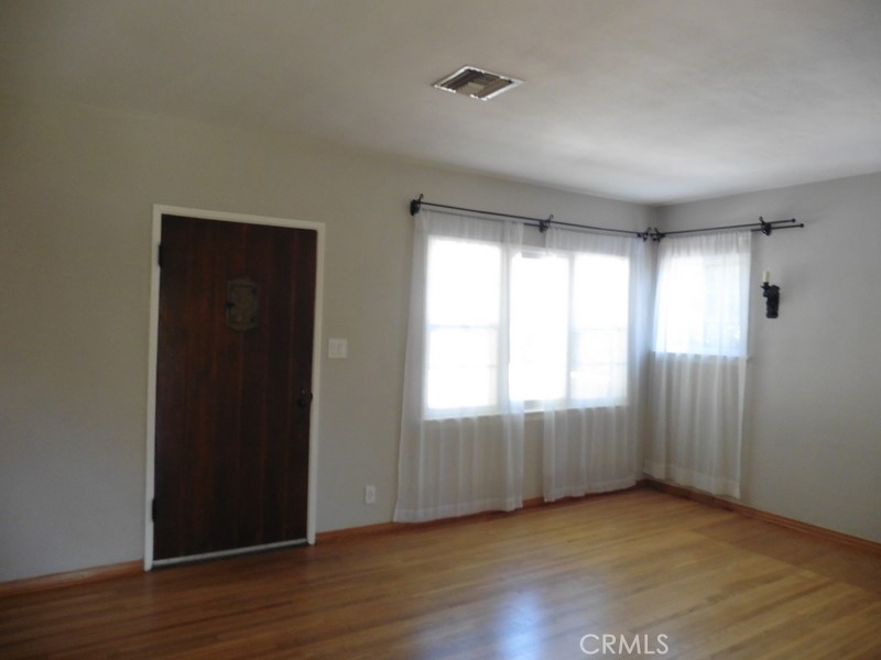 2658 San Marcos Drive Pasadena, CA 91107 - Photo 3 of 19 an empty room with wooden floor and windows