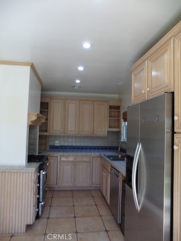 2658 San Marcos Drive Pasadena, CA 91107 - Photo 10 of 19 a kitchen with a refrigerator sink and cabinets
