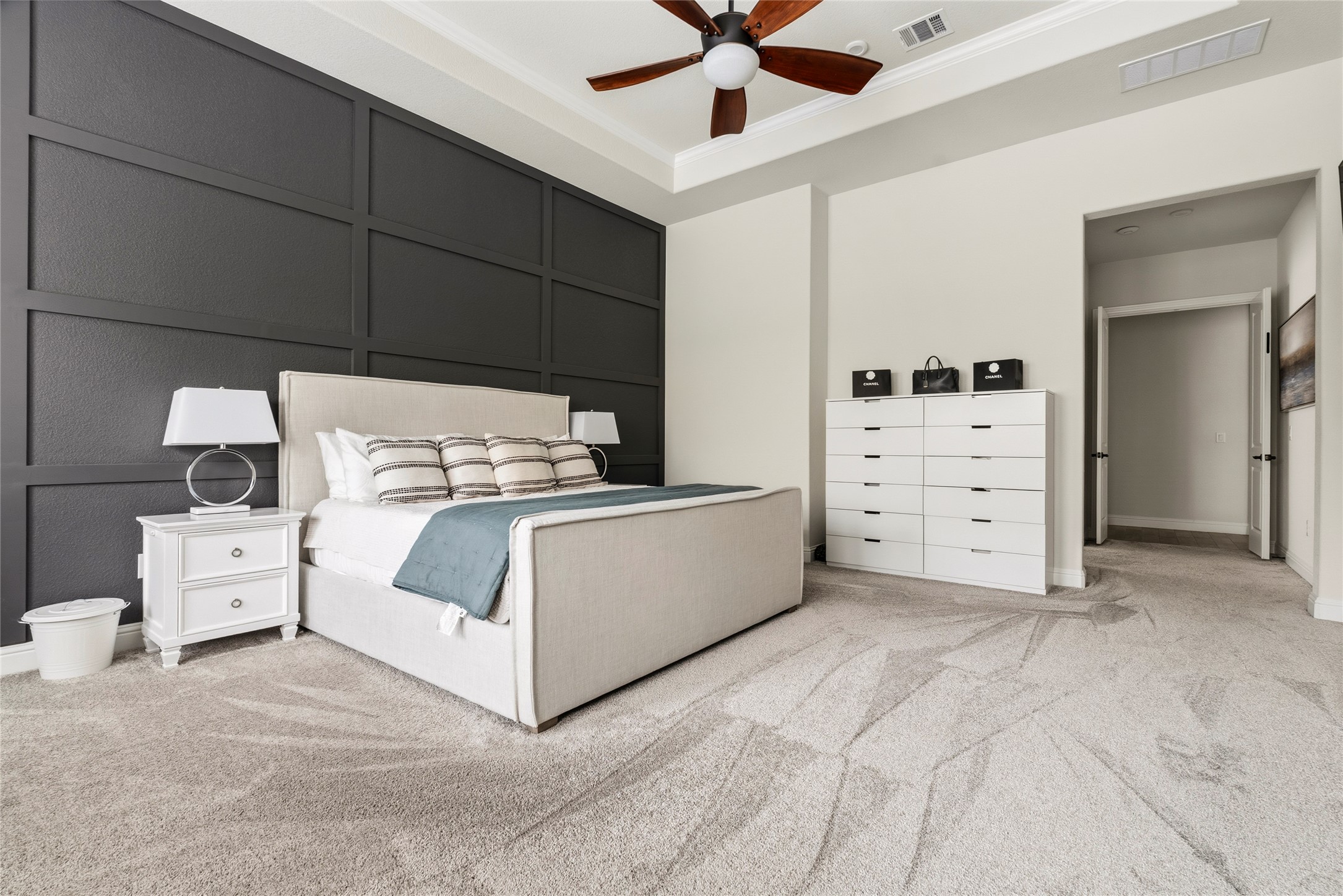 4513 Vieste View Leander, TX 78641 - Photo 26 of 40 Spacious room featuring a decorative accent wall, tray ceiling, and light-toned carpeting