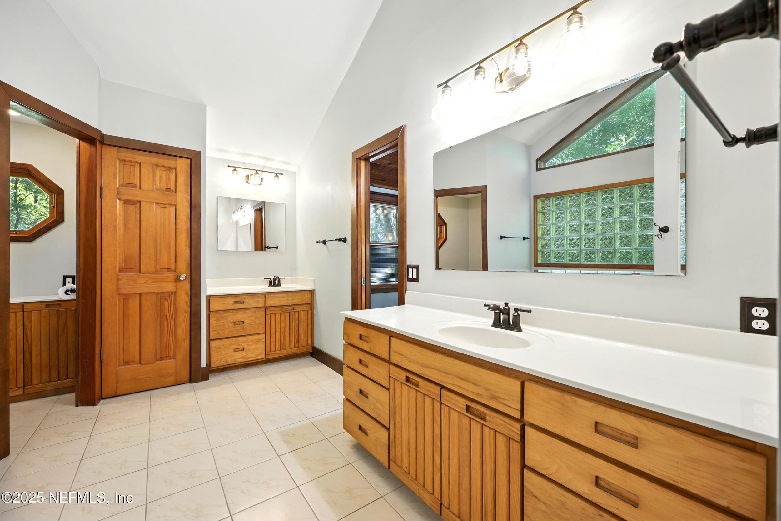 12534 Flynn Road Jacksonville, FL 32223 - Photo 26 of 90 a spacious bathroom with a double vanity sink a mirror and a bathtub