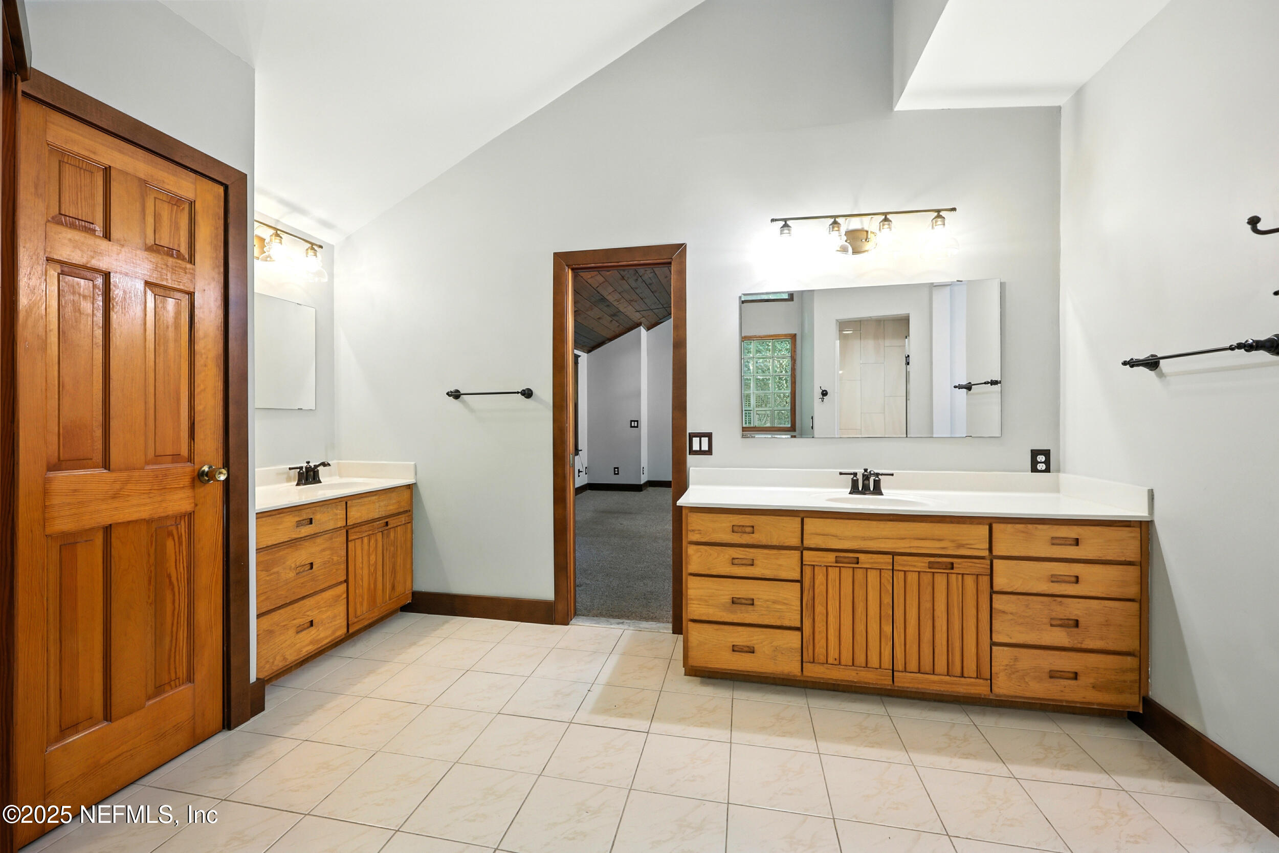 12534 Flynn Road Jacksonville, FL 32223 - Photo 28 of 90 a spacious bathroom with a double vanity sink a mirror a bathtub and a shower