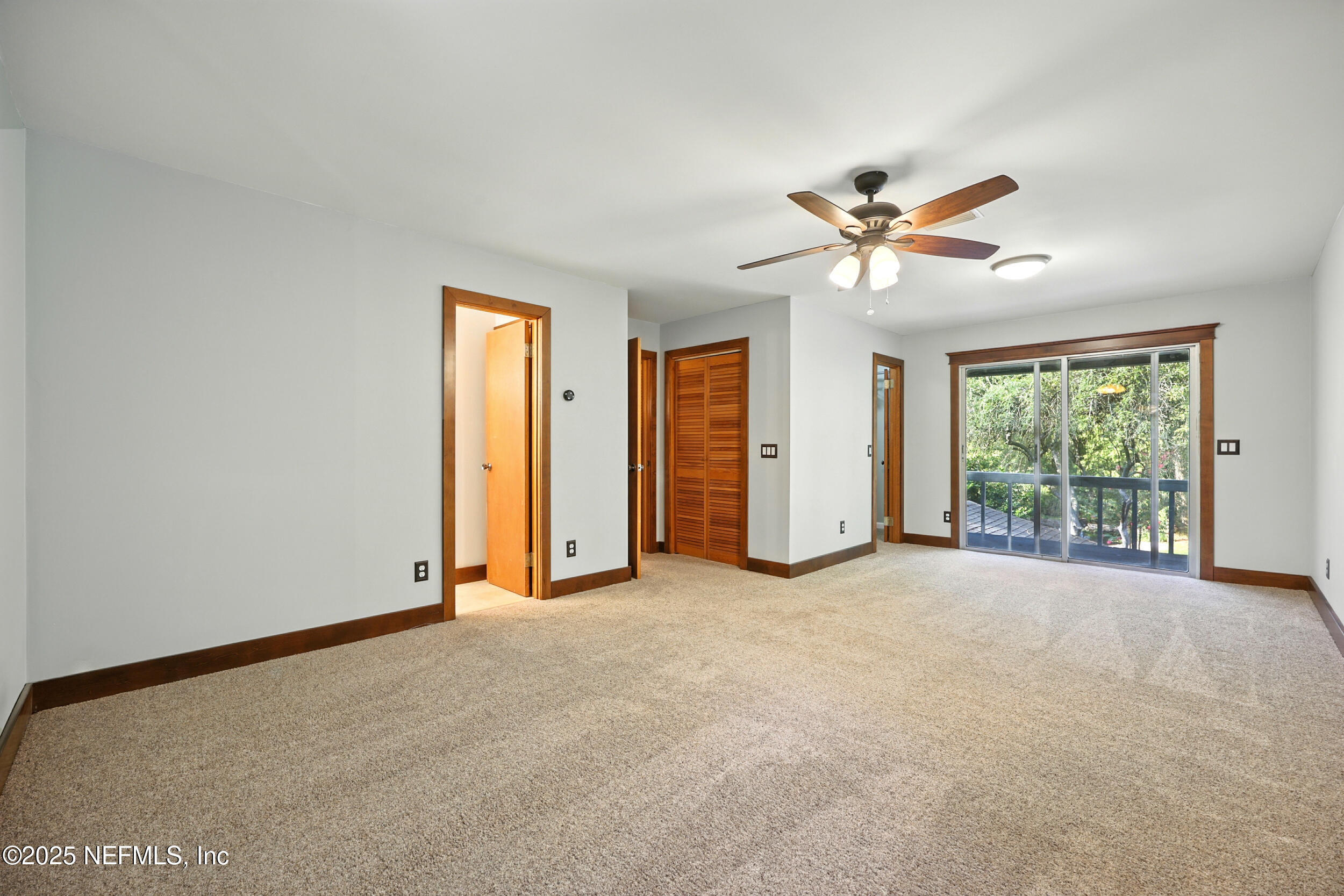 12534 Flynn Road Jacksonville, FL 32223 - Photo 37 of 90 an empty room with chandelier fan and windows