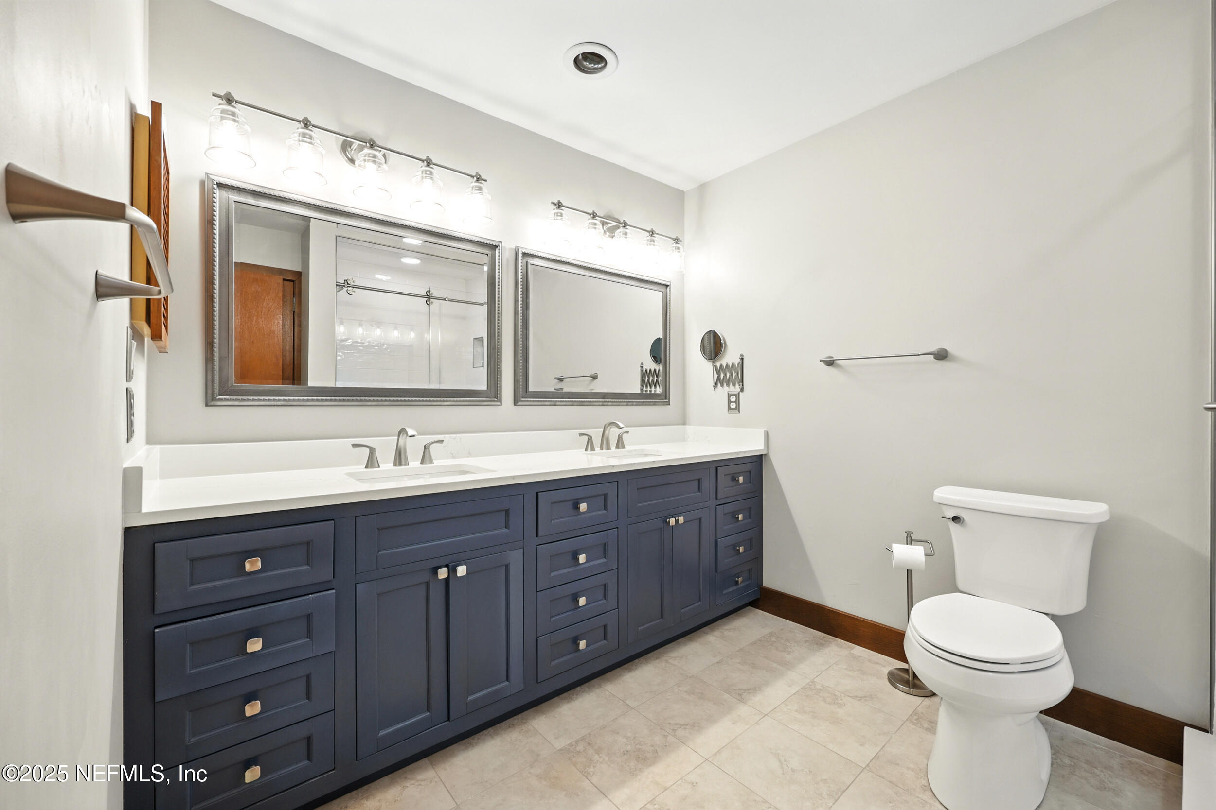 12534 Flynn Road Jacksonville, FL 32223 - Photo 39 of 90 a spacious bathroom with a double vanity sink mirror and toilet