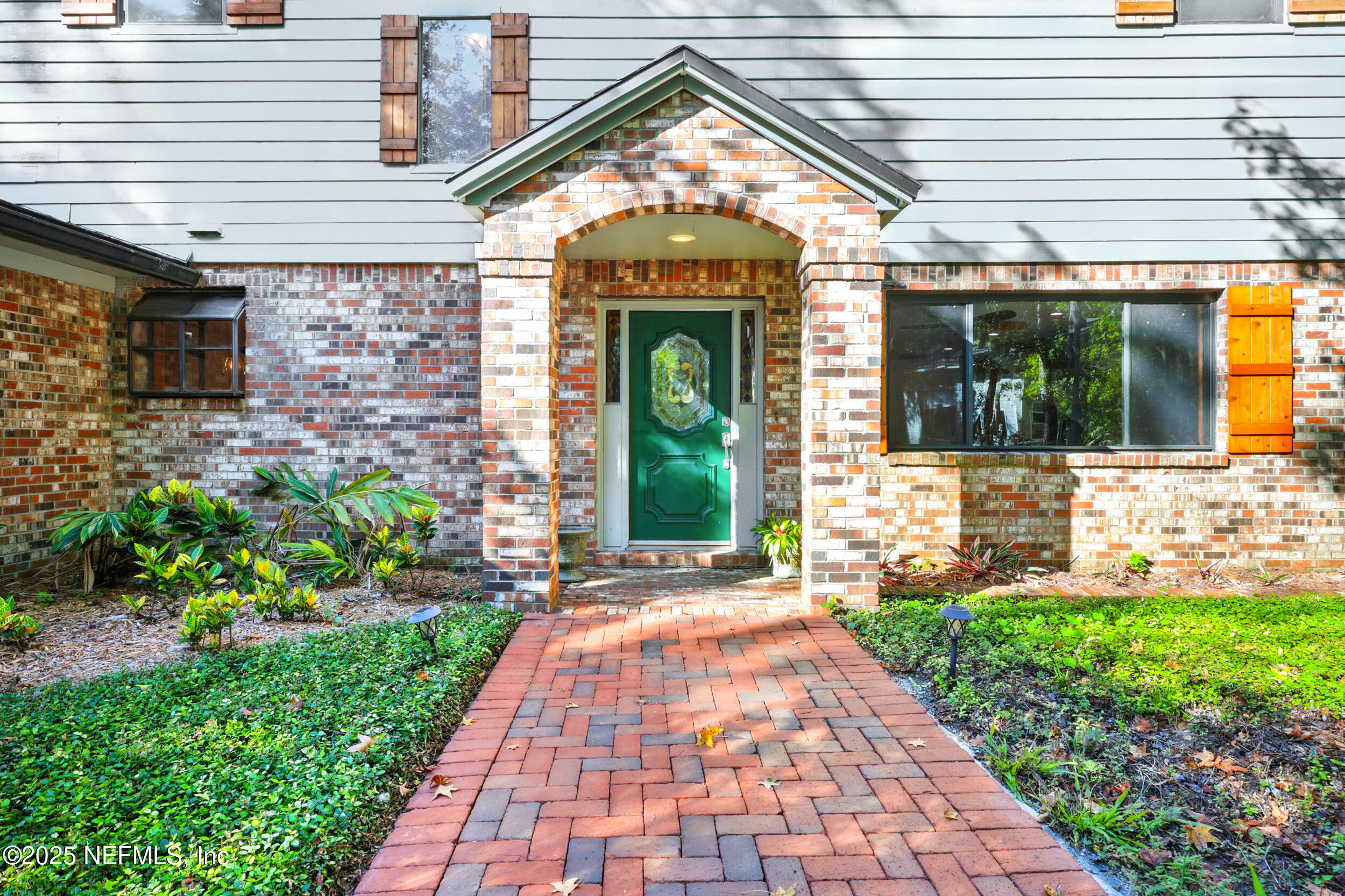 12534 Flynn Road Jacksonville, FL 32223 - Photo 5 of 90 a view of a brick house with a large windows