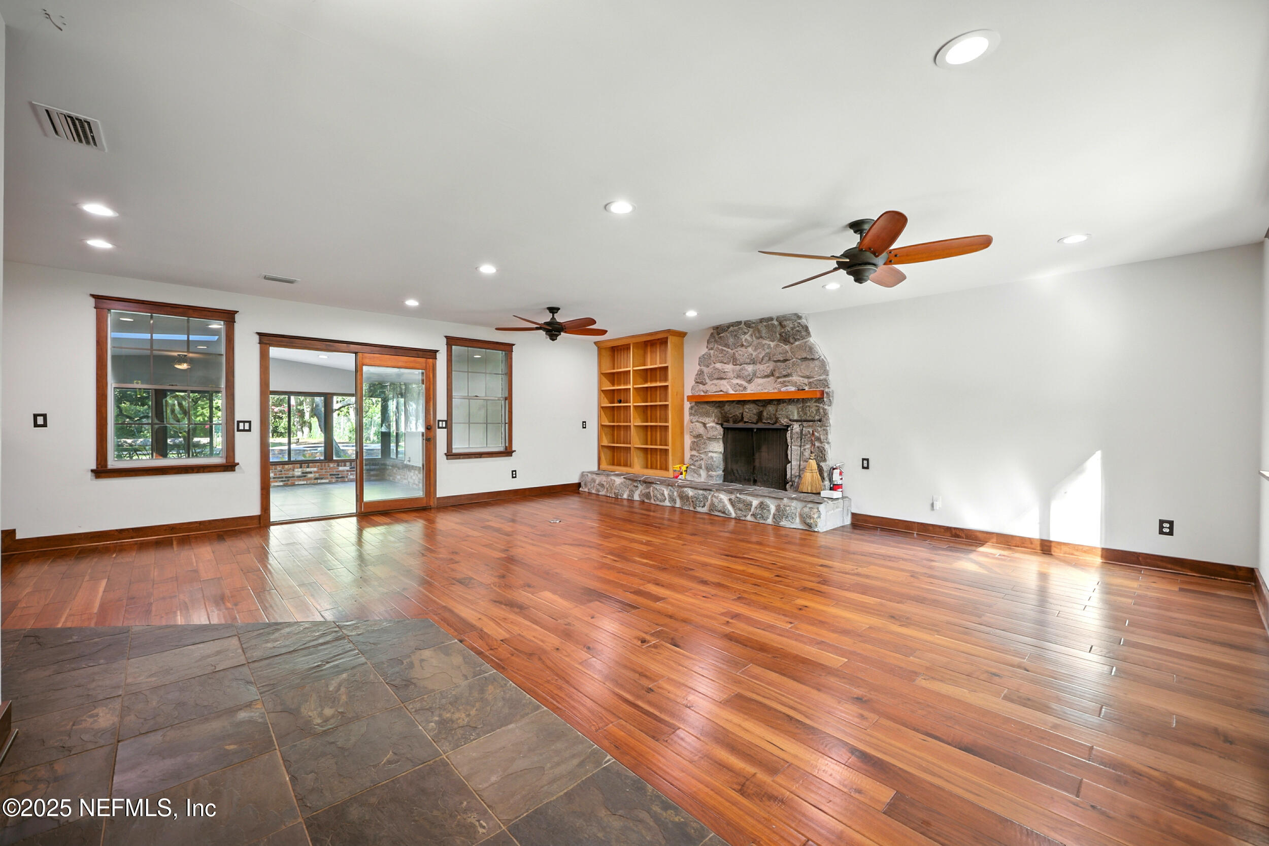 12534 Flynn Road Jacksonville, FL 32223 - Photo 6 of 90 a view of empty room with wooden floor and fireplace